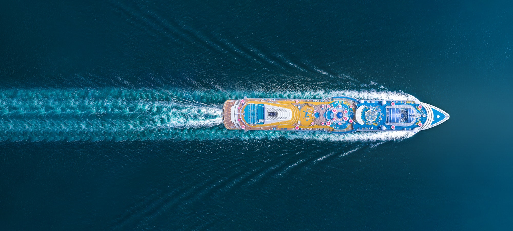 Aerial top view of beautiful white cruise running with contrail in the ocean sea, luxury cruise